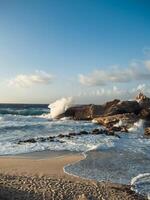 Ocean waves crash into the rock photo