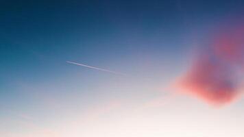 Airplane trail in the blue sky photo