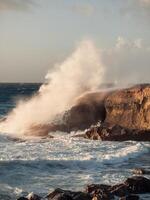 Sea waves crash into the rock. photo