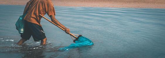 People catch fish that float on the surface of the water because they are poisoned by the roots of the tuba plant or Derris. environmental problems photo