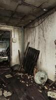 An abandoned room with a chair and a mirror, showing the devastation and decay video