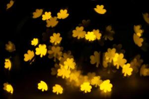 glare, bokeh, lights in the shape of clover leaves on a black background. for overlay photo