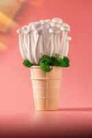 shimeji mushrooms with green moss in an ice cream cone, on peach fuzz background photo
