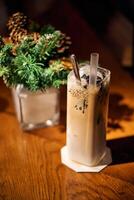 Ice chocolate in glass cups. Dark background with garland lights bokeh. Christmas and New Year sweet dfink and food holiday concept photo