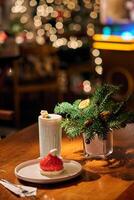 Smoothie in glass cups. Dark background with garland lights bokeh. Christmas and New Year sweet dfink and food holiday concept photo