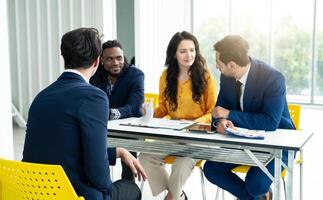 Job interview concept. Diverse hr team doing job interview with a man in business office. Human resources team interviewing a potential job candidate. Hiring, employment, and recruitment concept. photo