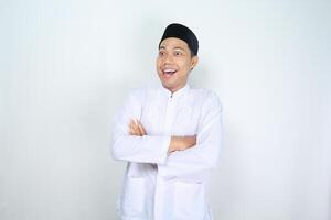 surprised muslim man asian looking away with cross hand isolated on white background photo