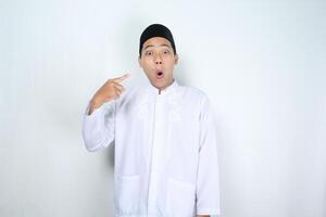 shocked asian man muslim pointing to him self isolated on white background photo