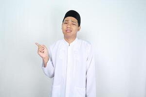 stressed muslim man asian pointing to empty side isolated on white background photo