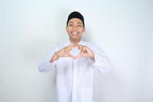 confident asian muslim man giving heart shape with smile at camera photo