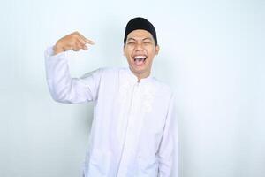 laughing asian muslim man pointing at him self isolated on white background, its me gesture photo