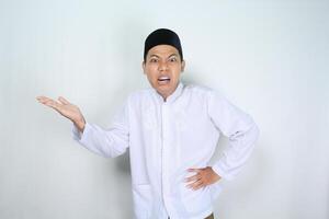 angry muslim asian man presenting to side isolated on white background photo