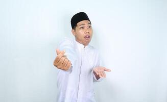 unhappy asian muslim man show korean love sign with confused face isolated on white background photo