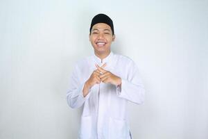 happy asian muslim man crossed finger show forbidden gesture with friendly smiling face isolated on white background photo