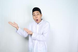 shocked asian man muslim raising hand to beside to presenting copy space isolated on white background photo