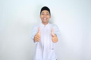 happy muslim asian man giving two thumbs up isolated on white background photo