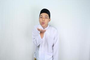 happy asian muslim man blow a  kiss at camera isolated on white background photo