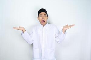 asian man muslim raising palm presenting to two side with shocked face expression isolated on white background photo