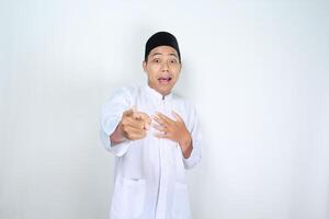 funny asian muslim man pointing hand forward with surprised expression isolated on white background photo