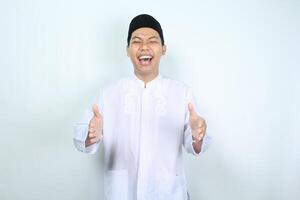 portrait of laughing asian muslim man holding imaginary box isolated on white background photo