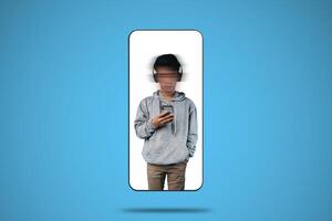 a student with a blur on his face is looking at a gadget on a blue background photo