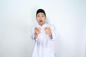 asian man muslim pointing forward with shocked expression isolated on white background photo