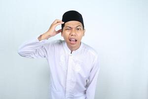 asian muslim man looking at camera with confused expression isolated on white background photo