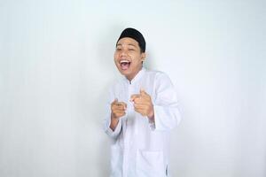 attractive muslim asian man pointing forward and shouting with mouth open isolated on white background photo