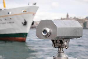 Coin-operated binoculars looking out over city , photo