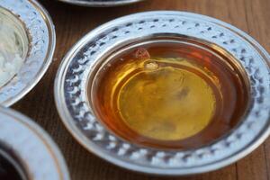 close up of fresh honey in a small silver container photo