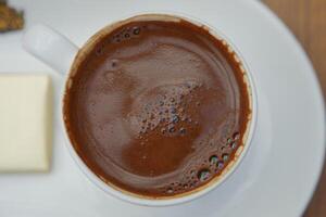 a cup of turkish coffee on table photo