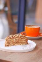 caramel cake and a coffee cup on table photo