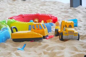 sand and colorful toys in a playground indoors. photo