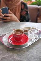 a cup of turkish coffee on table photo