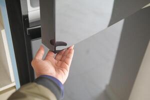 hand open the fridge door photo