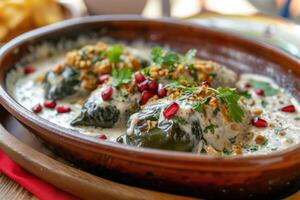 AI generated Mexican cuisine Chile en Nogada stuffed poblano chiles with creamy sauce, pomegranate seeds photo