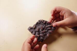 child holding a dark chocolate candy photo