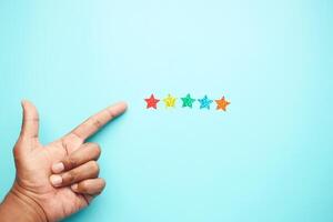 Customer review concept. Rating golden stars on blue background photo