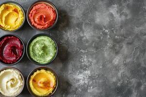 AI generated colourful hummus dips surrounded by various cut vegetables, pita bites, breadsticks photo