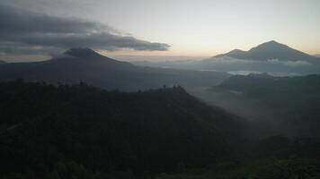 Sunrise in Kintamani Bali Indonesia Coffee Shop looking at Mount Batur Volcano Blanket Clouds in the Morning video