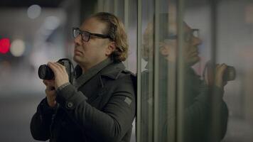 Male Traveler Taking Photo on Crowded Urban City Street at Night video