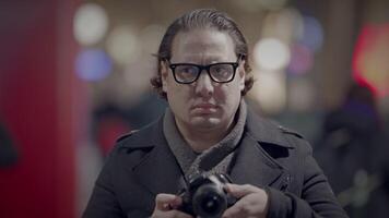 Male Traveler Taking Photo on Crowded Urban City Street at Night video