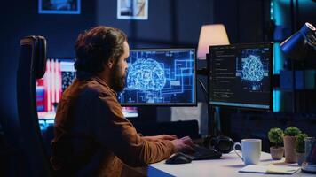 Software developer writes code on multimonitor setup PC to visualize artificial intelligence neural networks. Teleworking IT employee runs AI script on computer from home office, camera A video