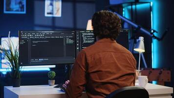Admin using javascript coding language to fortify security and safeguard consumer data, remotely working for IT company. Software developer upgrading binary code scripts on computer terminal, camera A video