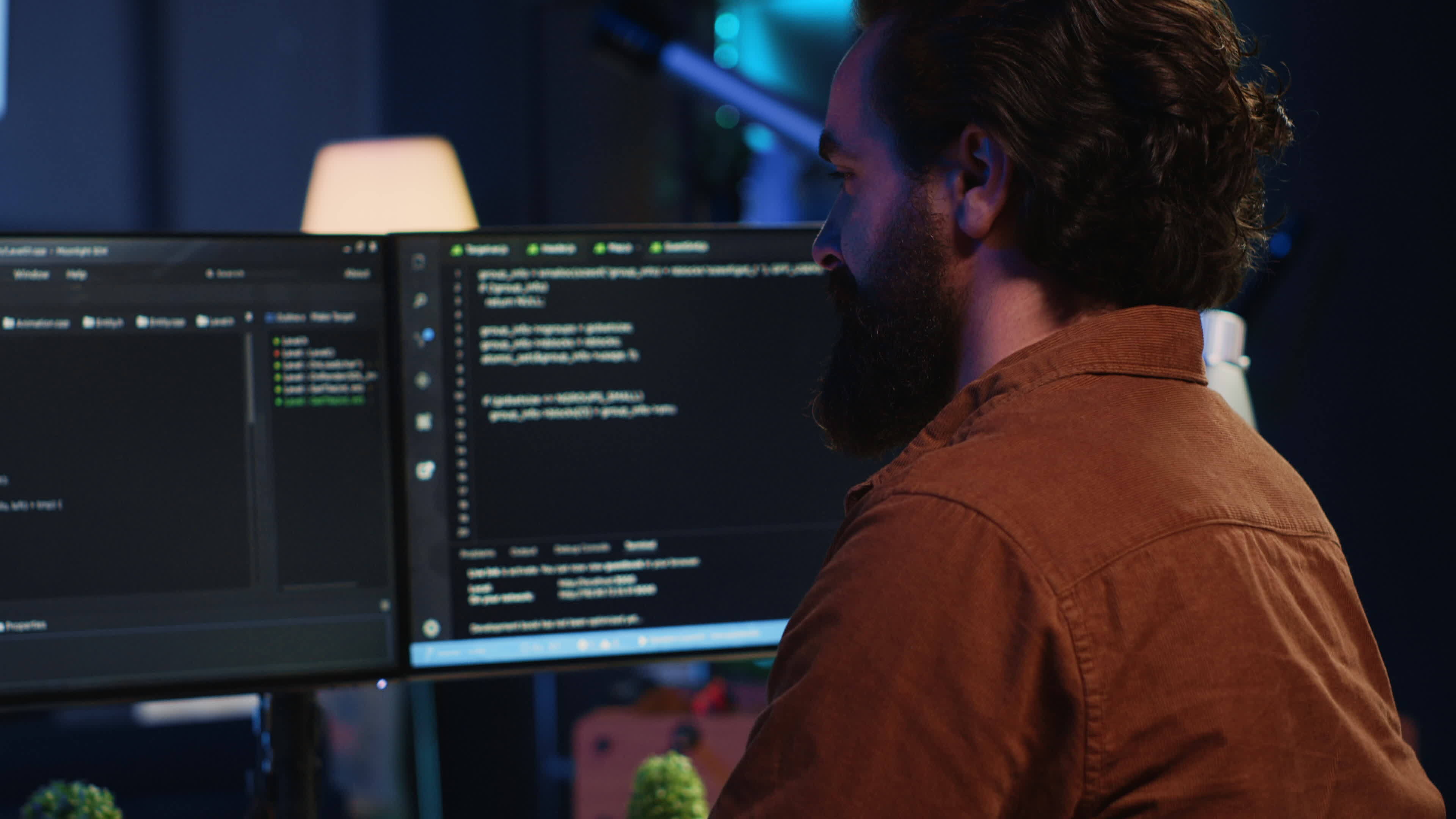 Smiling freelancing developer in home office doing coding on computer ...