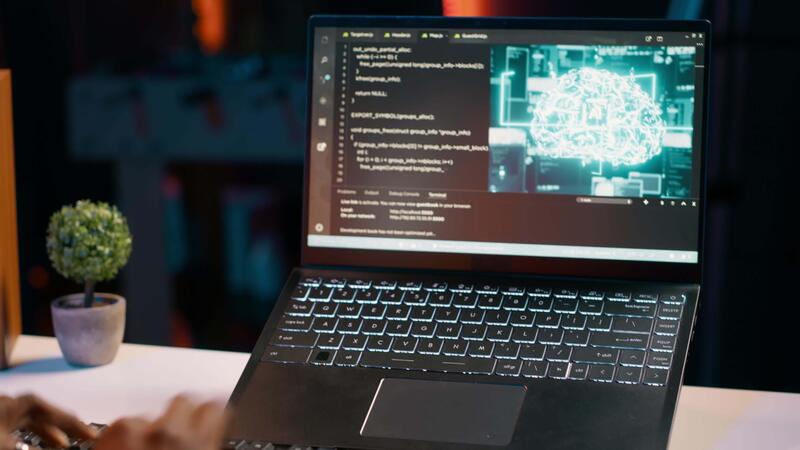 IT student works with artificial intelligence brain system on laptop ...