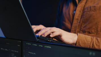 Programmer concentrating on writing complex binary code scripts on laptop terminal, close up shot. Teleworking IT specialist standing in home office, using programming to safeguard consumer data video