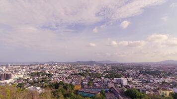 timelapse aerial landscape view of phuket town city skyline with many buildings housing in the central business district with background of bay area and seascape ocean in daytime. video