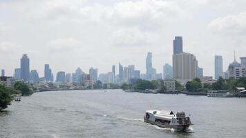 panorama landscape view of chaopraya river with river water boat transportation and background of bangkok city skyline with many highrise skyscraper video