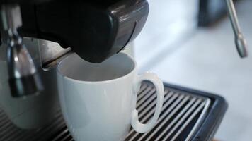 Coffee machine filling a cup, Making coffee by coffee machine into cup, espresso coffee coming out from automated coffemaker machine. video